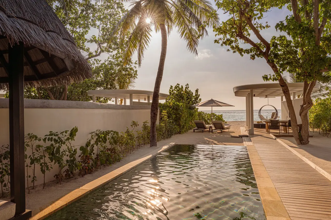 A Sunset Beach Villa’s long pool, with the gazebo and the sea at the end