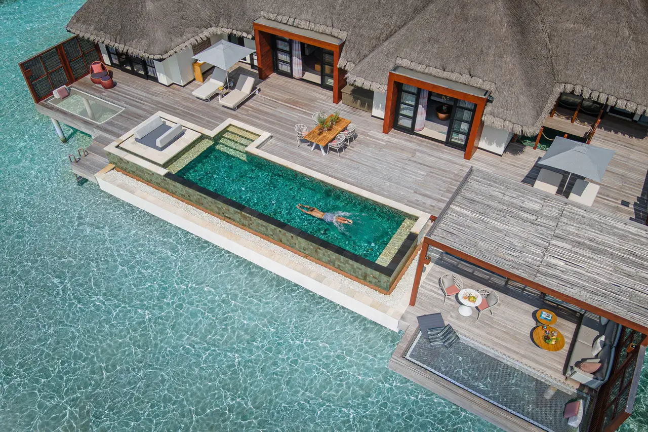The Sunset Two-Bedroom Water Suite from above, its pool and deck over the lagoon
