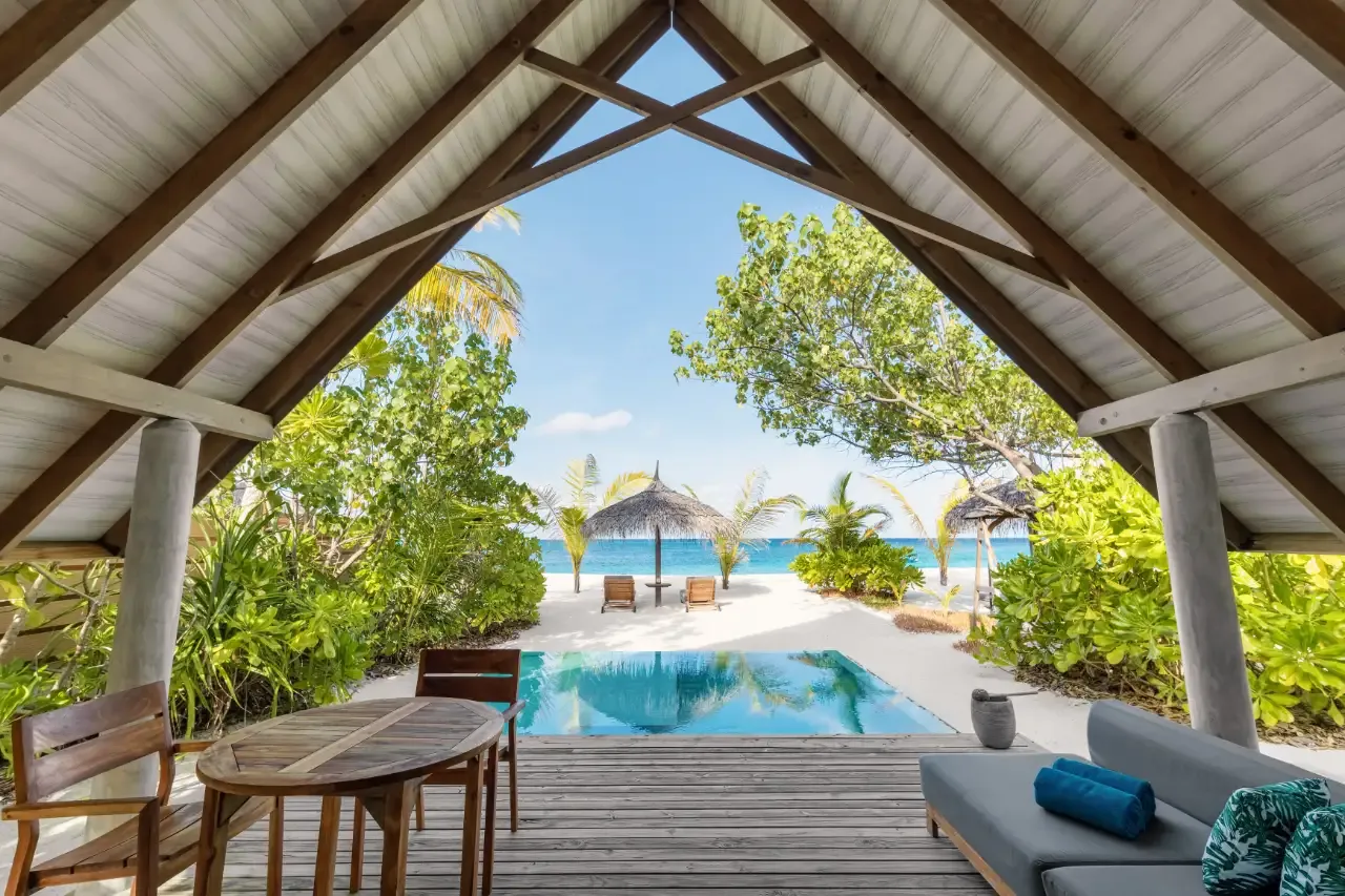 From the sala of a Beach Duplex Villa: the table, the pool and the beach.