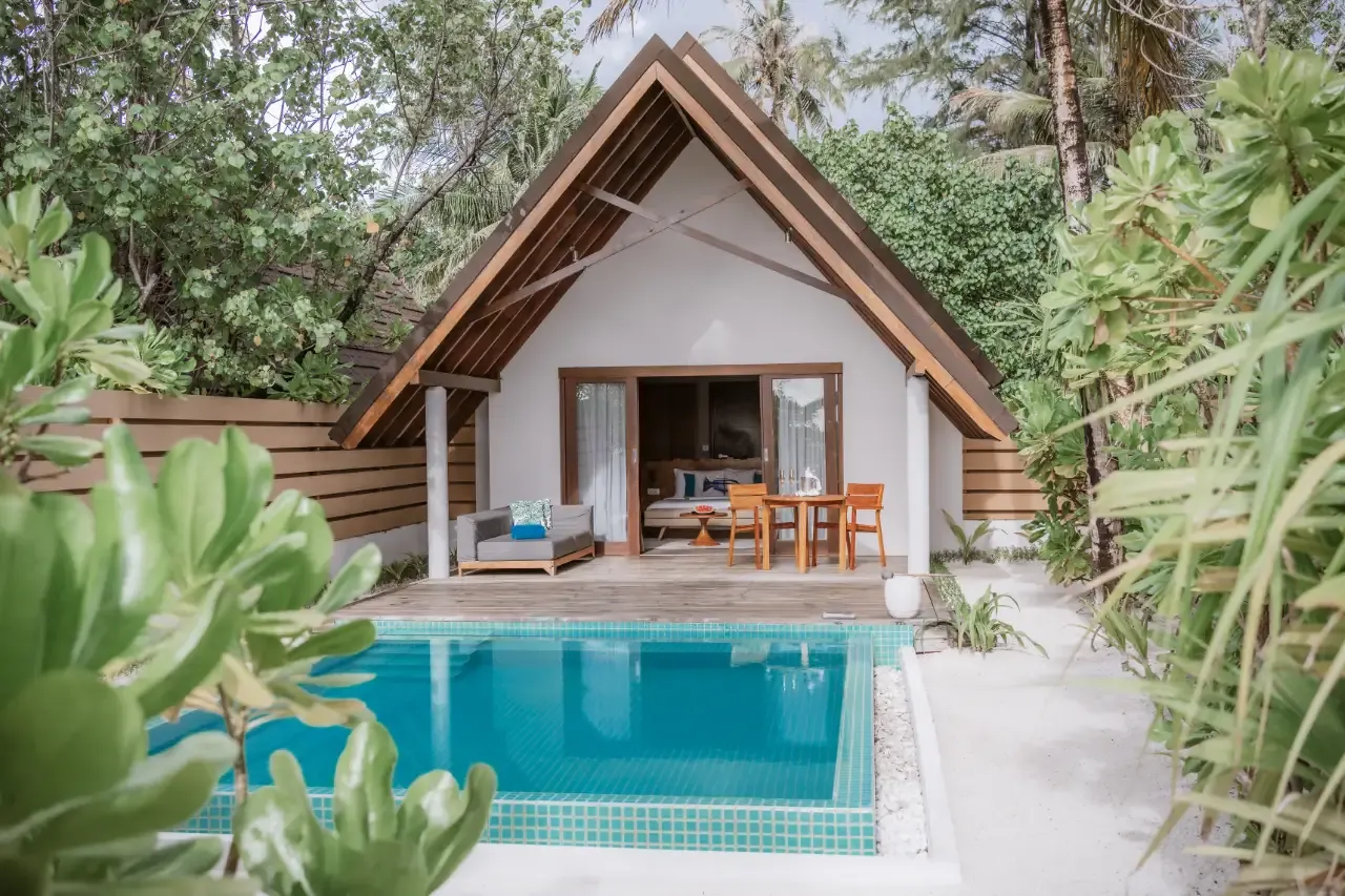 A Pool Beach Villa Sunrise with its pool among the greenery.