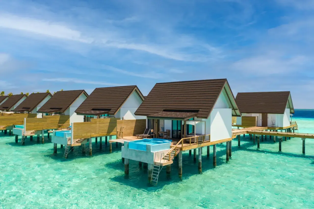 The water villas in a row over the lagoon, with pools on their decks.