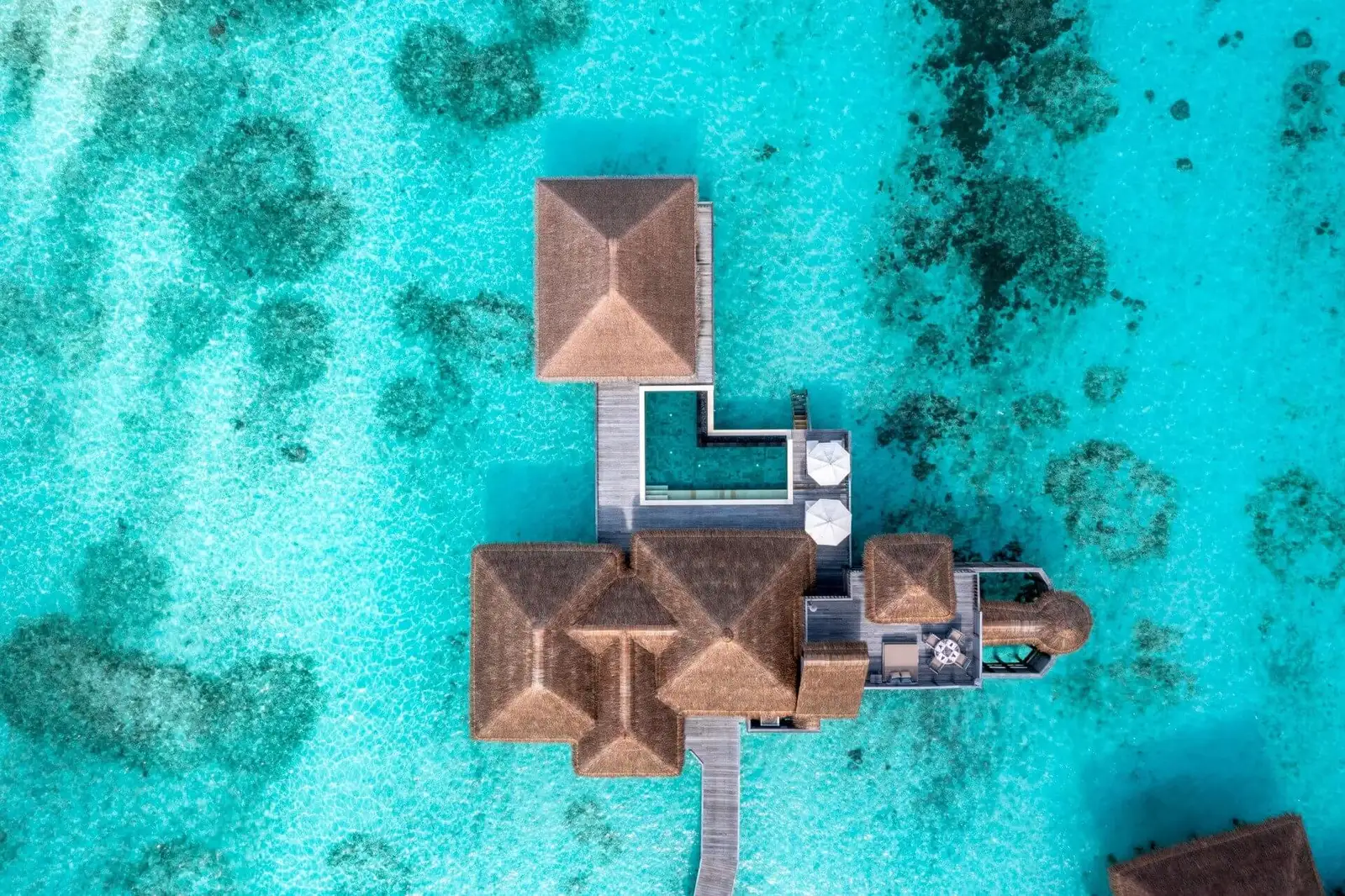 A Two-Bedroom Villa with Pool seen from above, its L-shaped pool on the deck