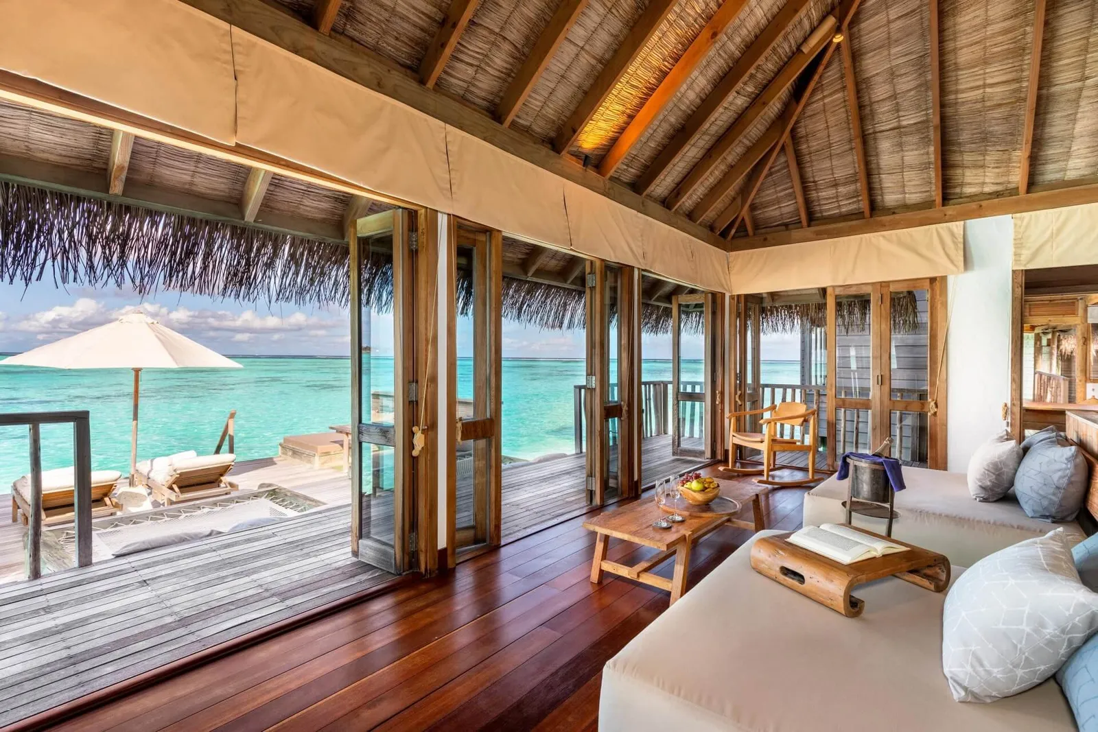 A Residence’s living room, sofas and the deck over the sea
