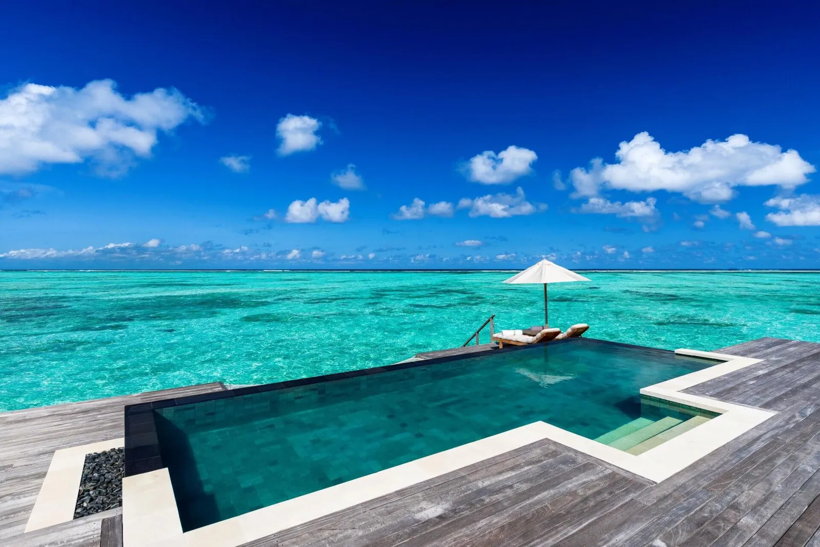 A Residence with Pool’s pool, on the timber deck facing the sea