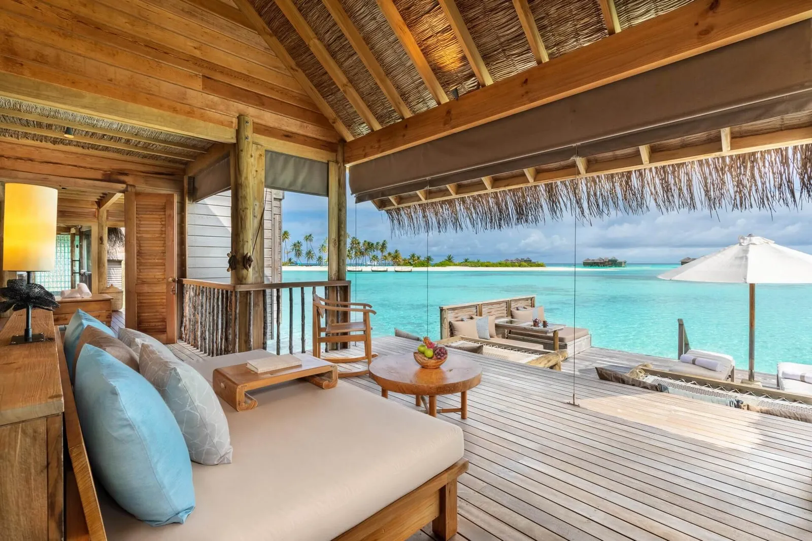 A Villa Suite’s living room, open to the deck and the lagoon