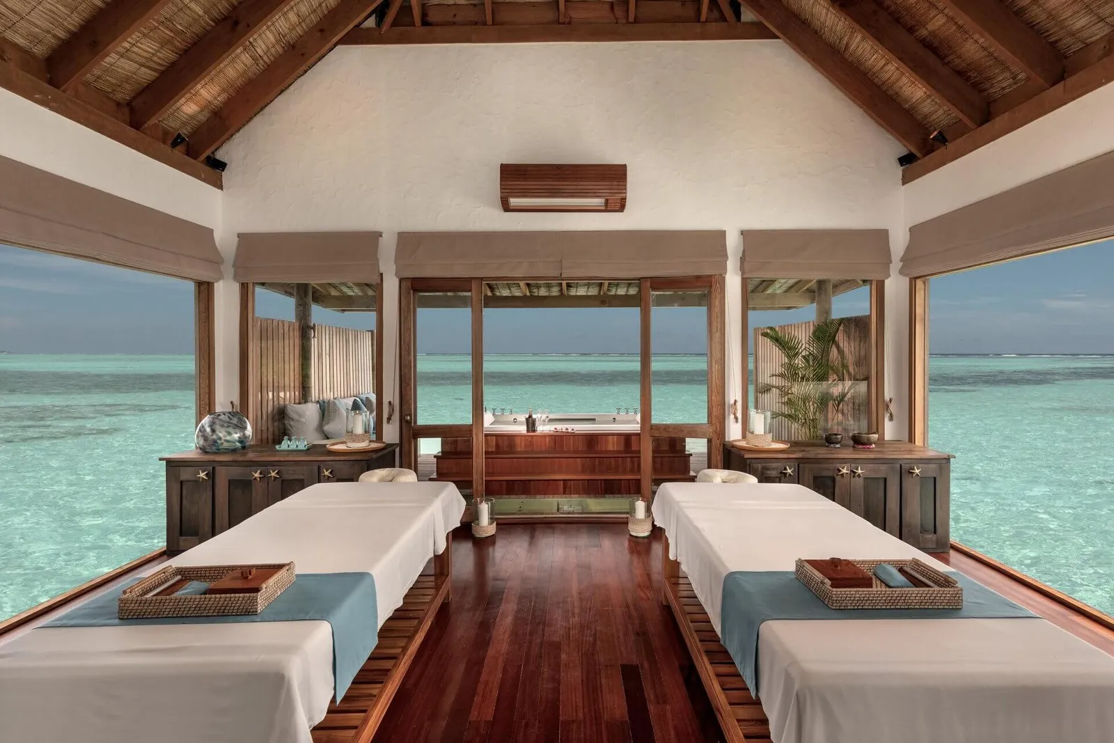 A Meera Spa treatment room: 2 beds and windows onto the lagoon