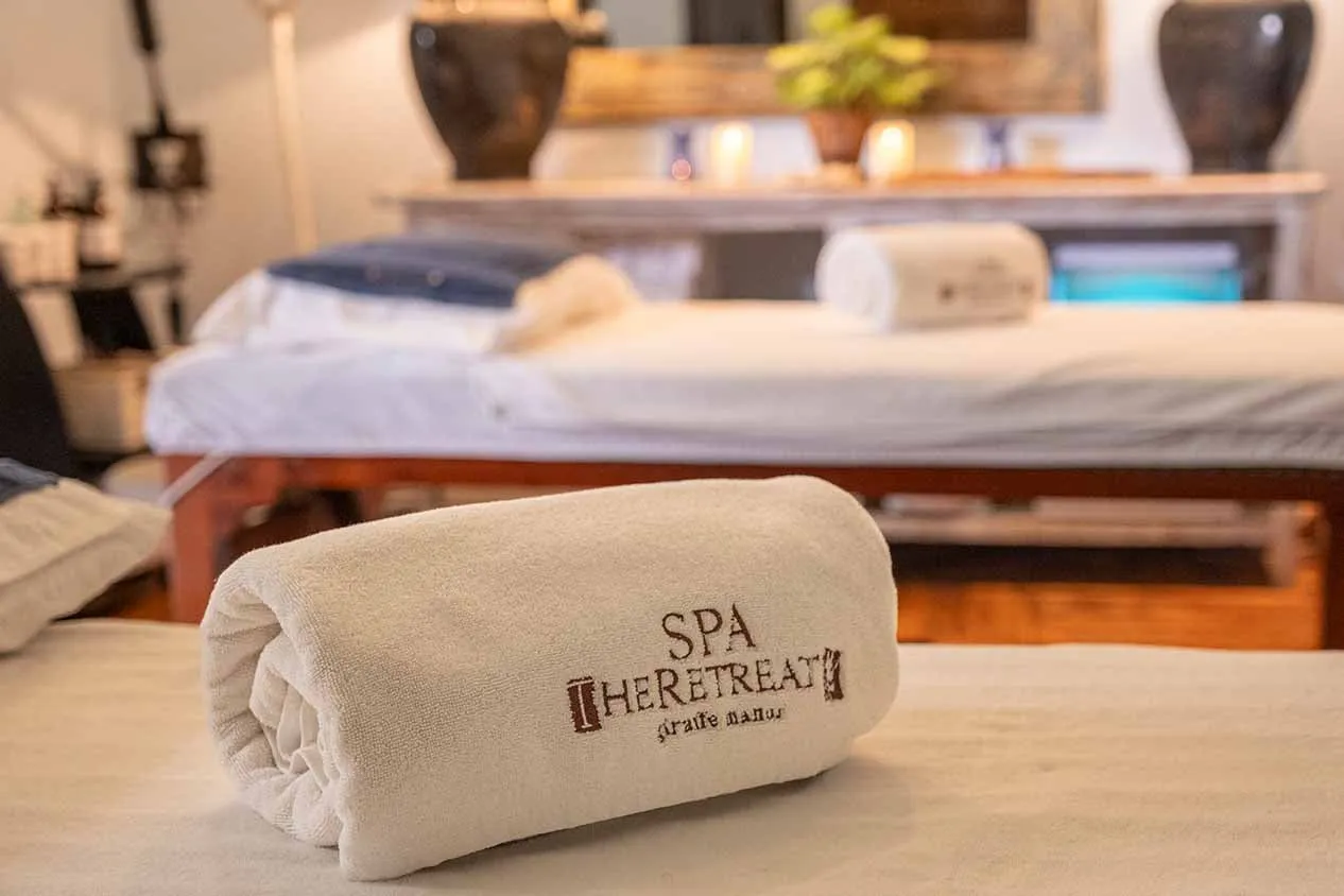 A treatment room at The Retreat spa, a folded towel on the bed