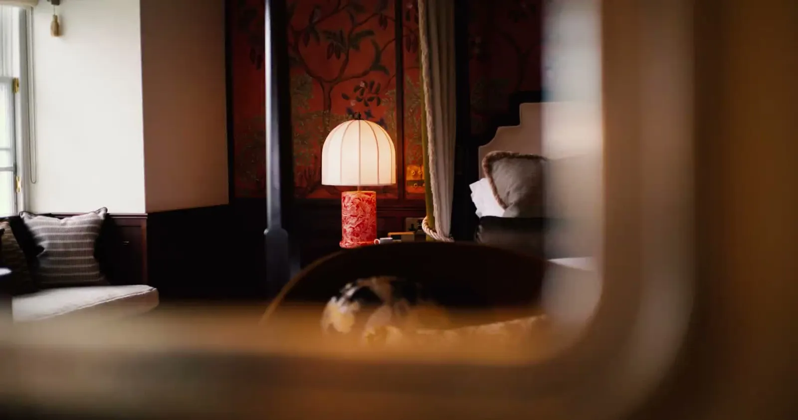 The Tower Suite: a red lamp and the painted wallpaper