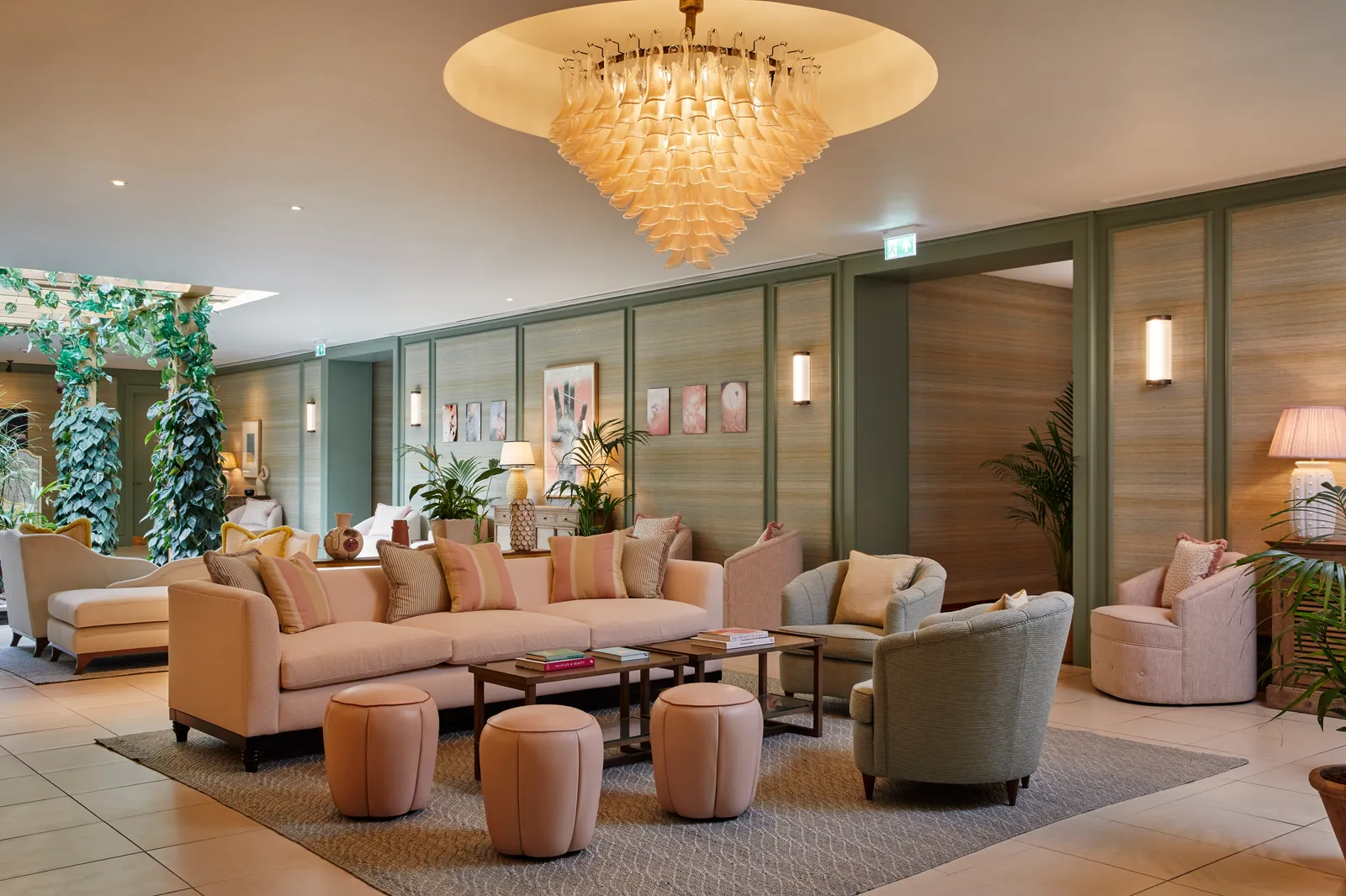 The spa’s relaxation courtyard, sofas and plants under a chandelier