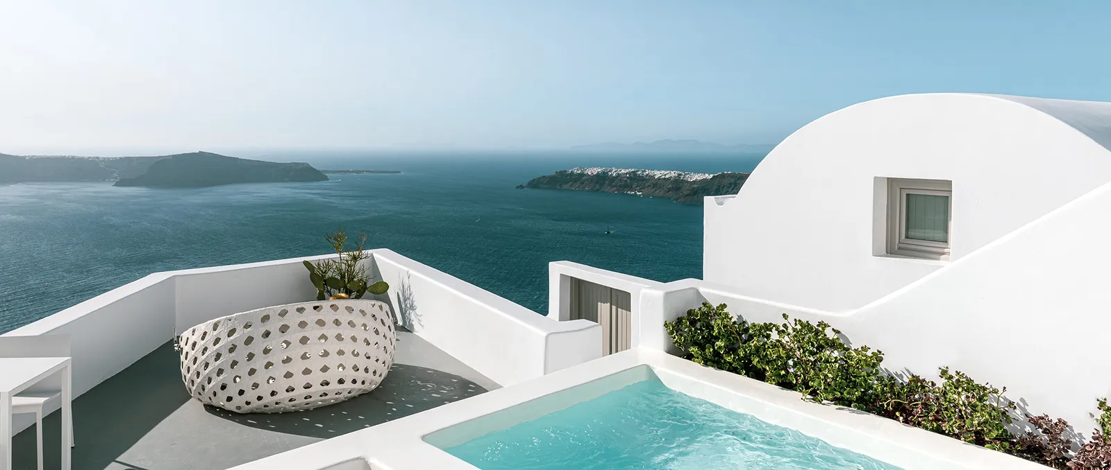 A Junior Suite with Plunge Pool terrace: the turquoise pool, the round daybed, a white dome and the sea.