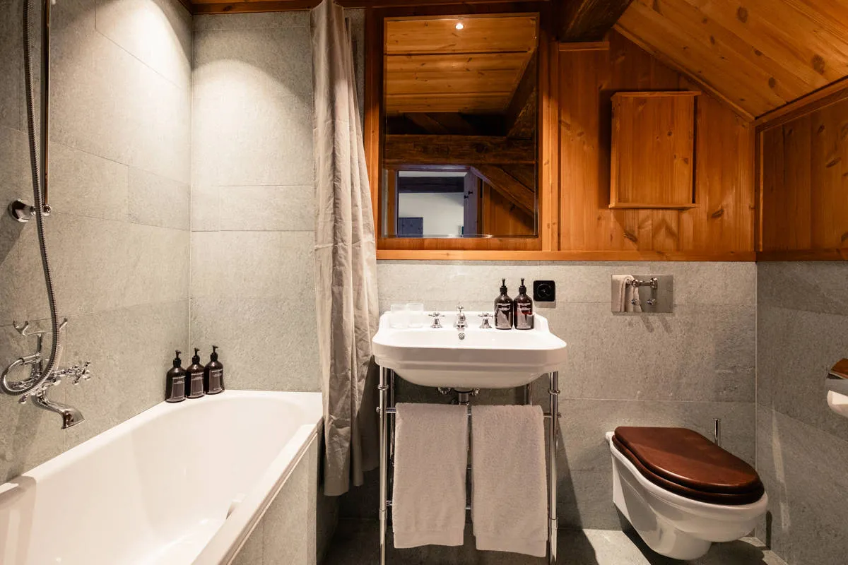 The bathtub beneath the beams in Prestige Attic Jungfrau View