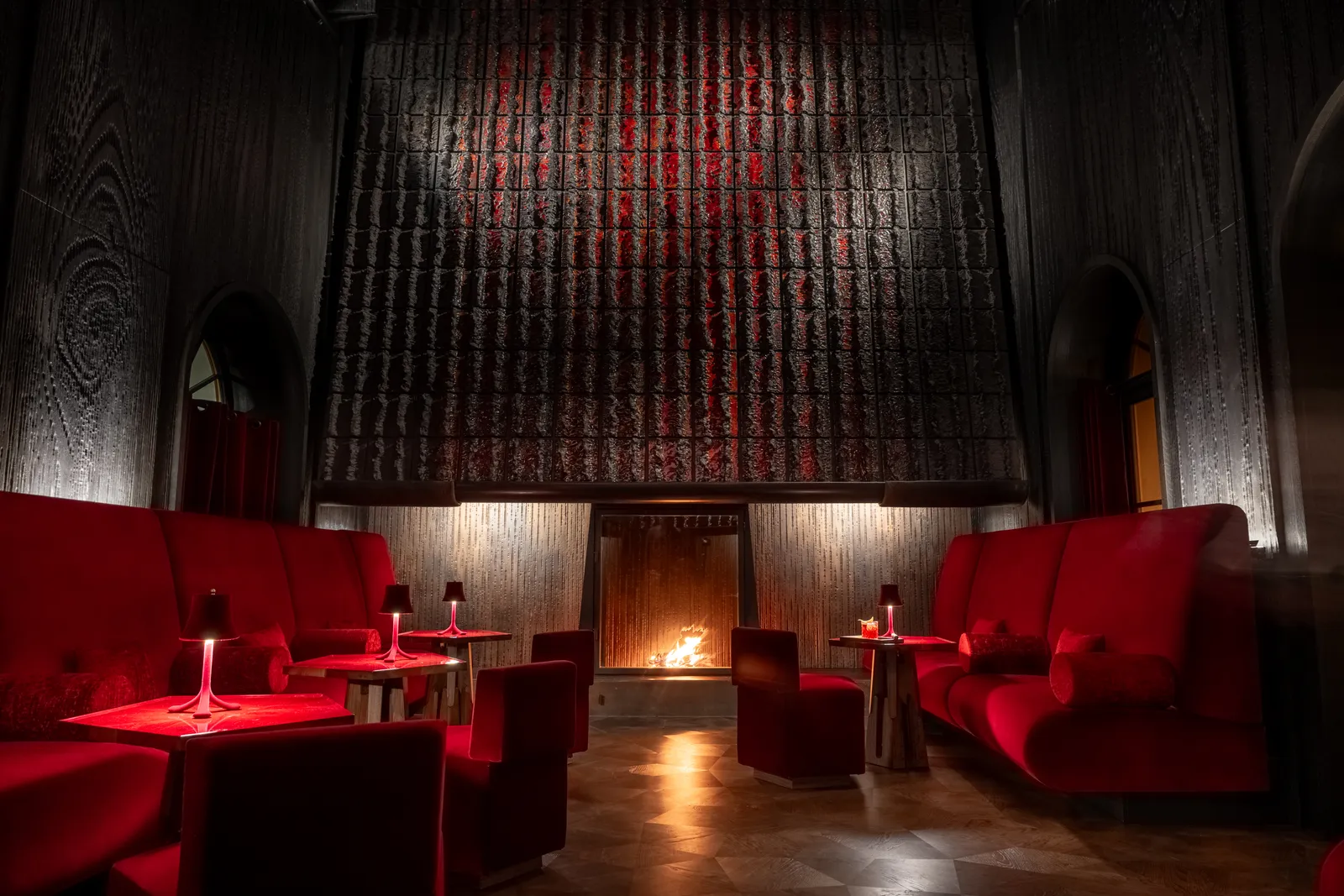 The red sofas and fireplace of The Council
