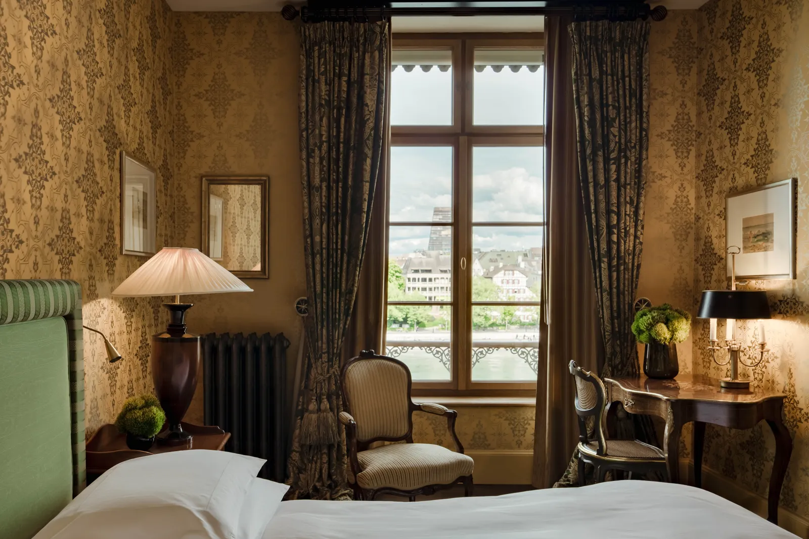The bedside table and window of the River Queen Room