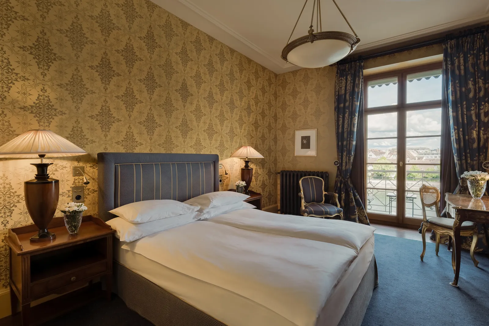 The bed and window of the River Queen Room Balcony