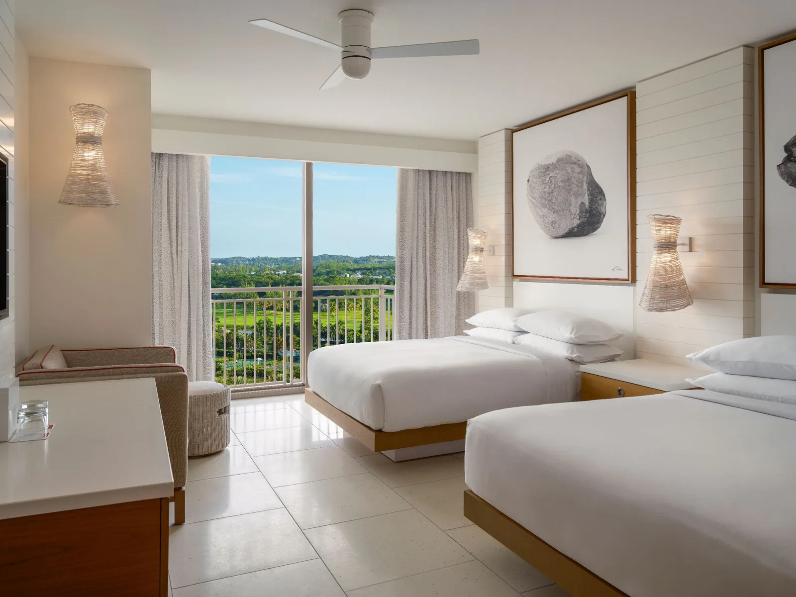 2 queen beds facing the glass door, which looks south over the golf course and the island.