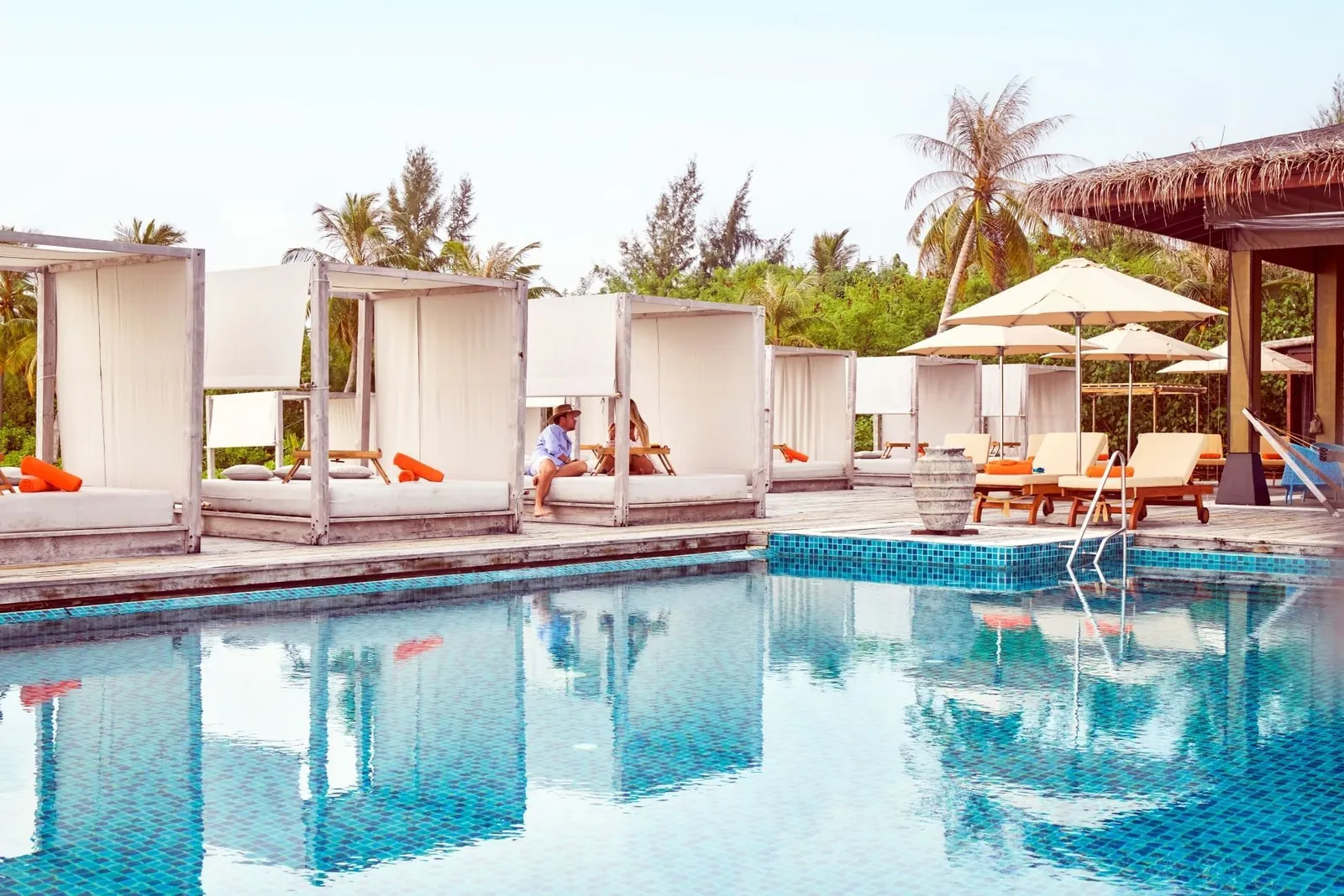The pool at Breeze with its white cabanas, the loungers under the parasols and the palms.