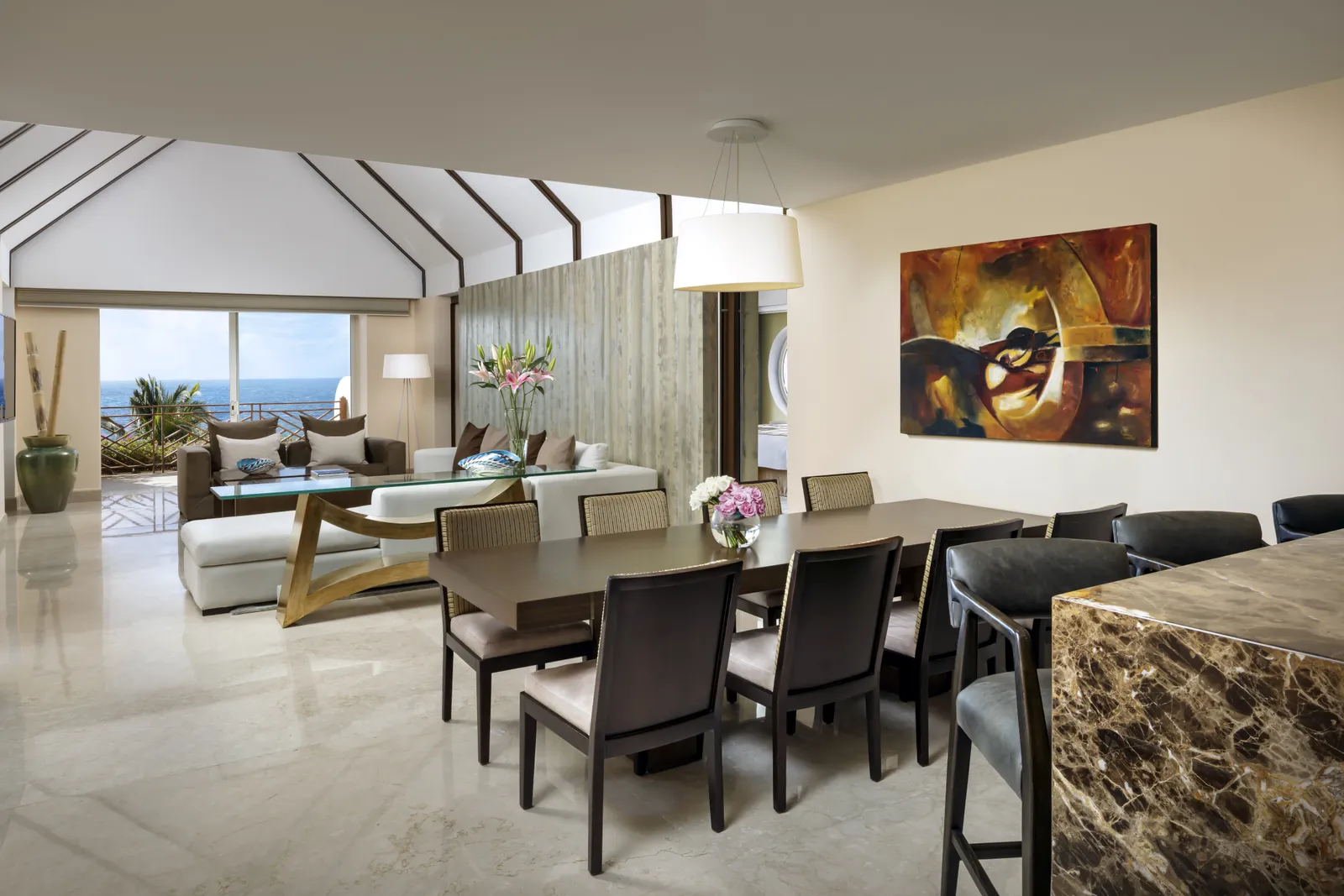 Dining table and living room in the Ambassador Presidential Suite