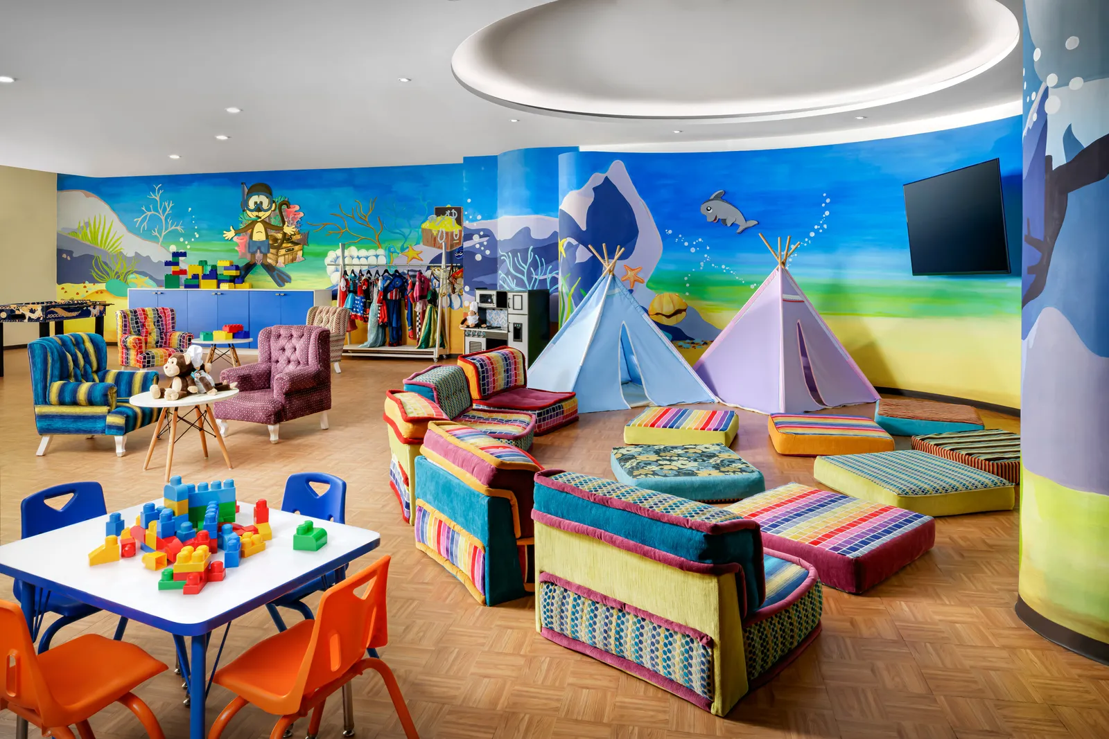 Small tables, toys and tepees inside the Kids’ Club