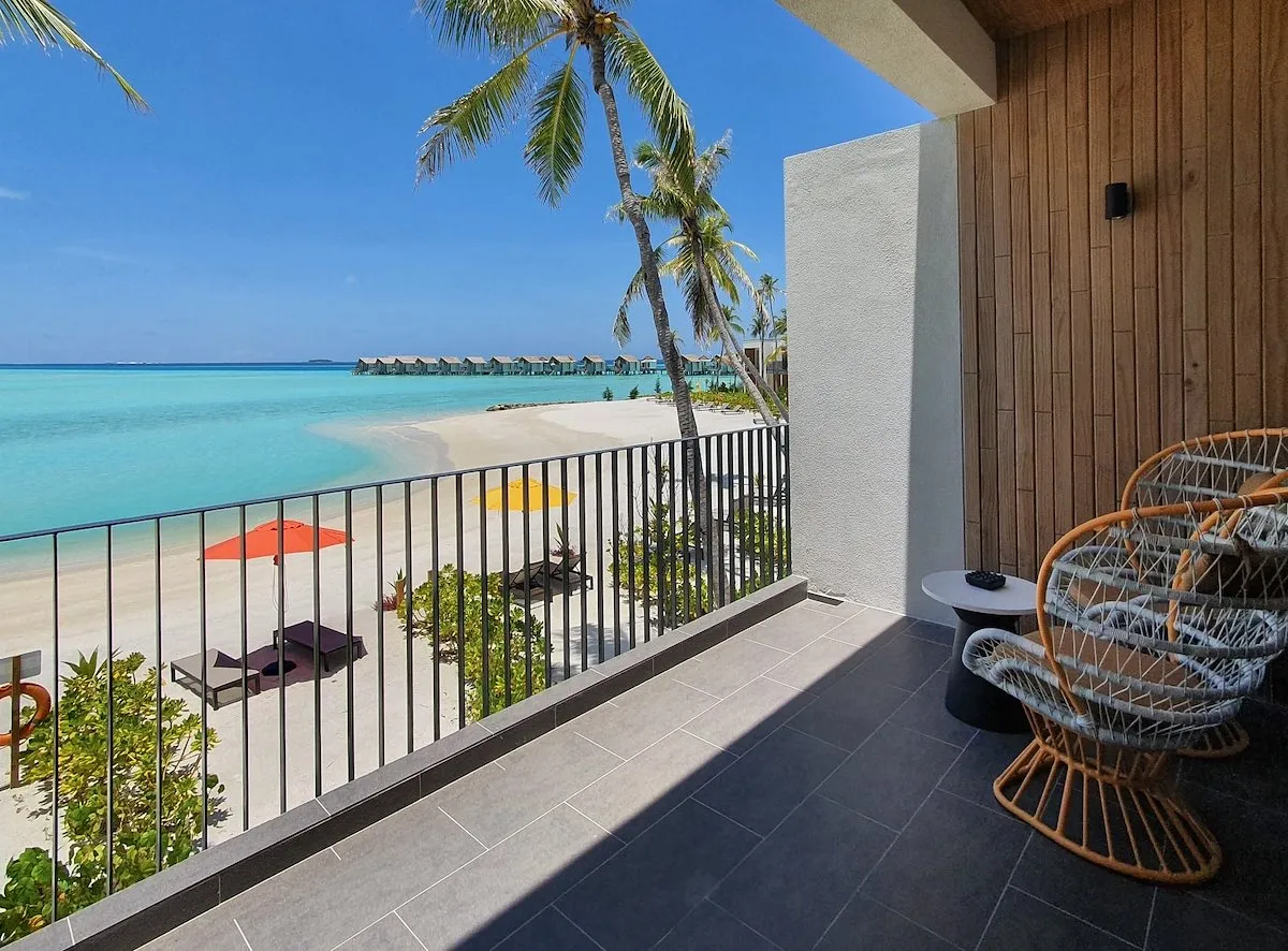 A Silver Sky Studio balcony above the beach, the water villas on the horizon