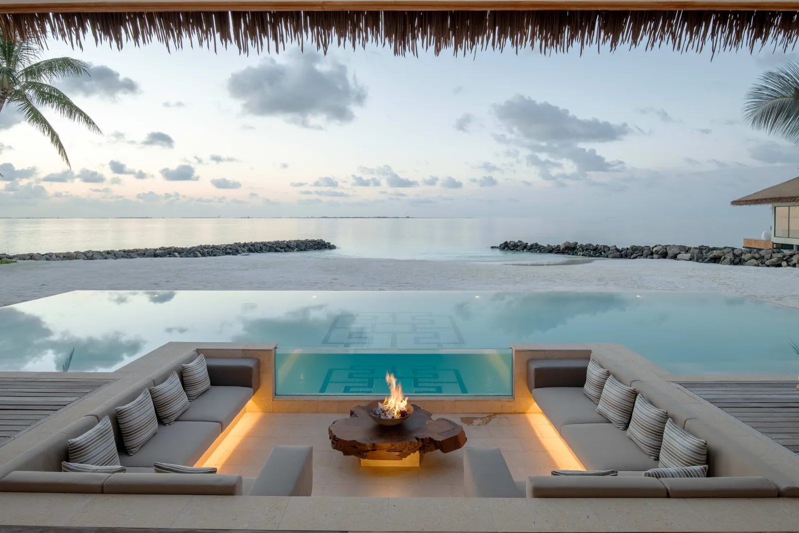 The sunken lounge and fire pit beside The Residence’s pool, facing the beach.