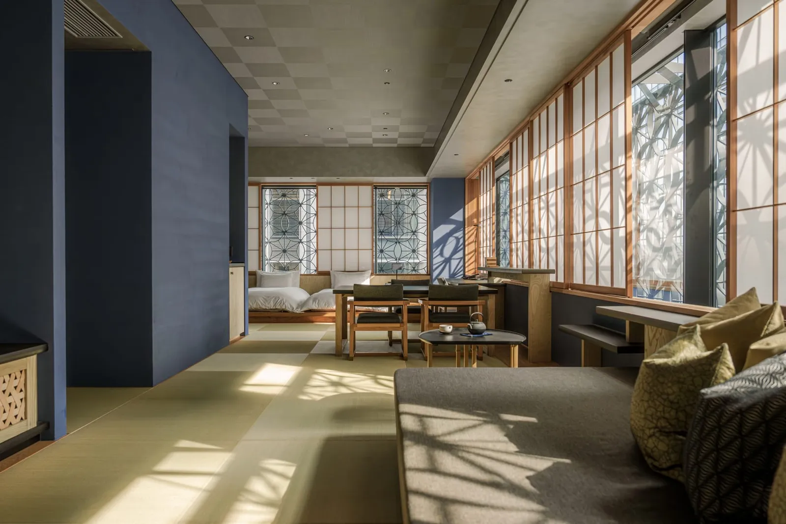 Kiku seen end to end: the tatami, the blue wall, the dining table and daylight from the windows.