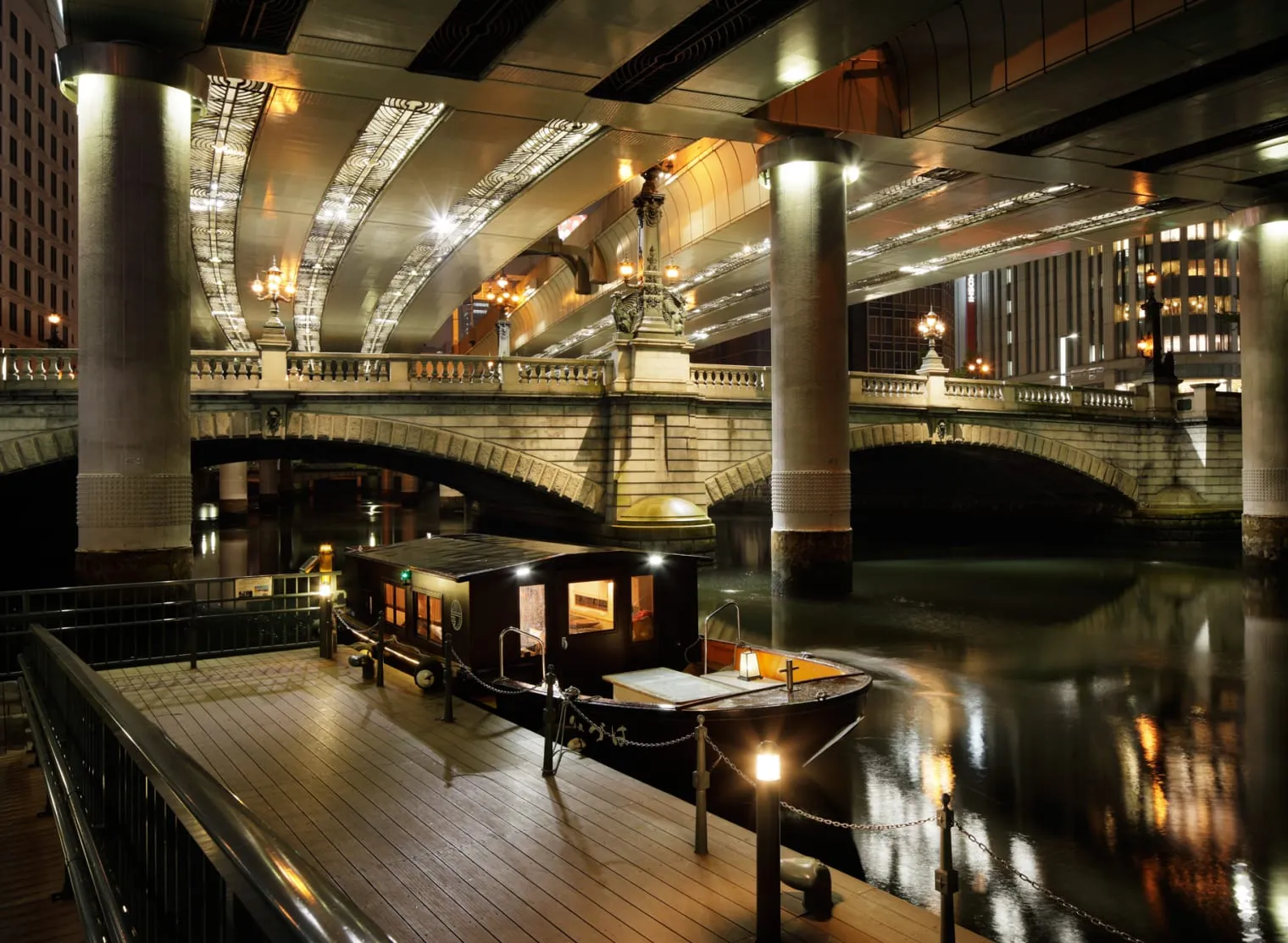 The Nihonbashi pier at night, a wooden boat under the stone bridge and the expressway.