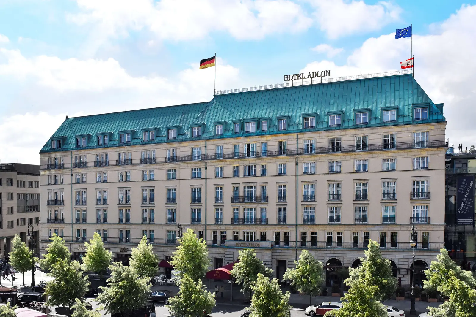 The Adlon’s pale façade, green roof and trees along Unter den Linden.