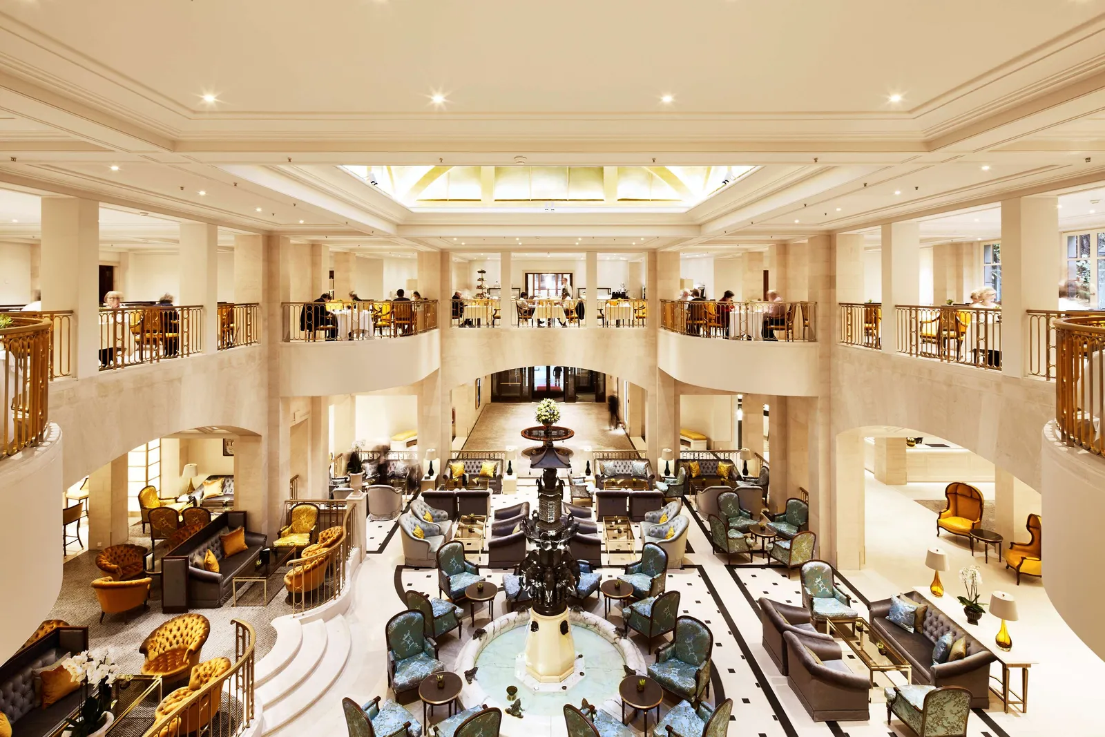 The lobby from the Bel Etage gallery, with the fountain below and tables along the balcony.