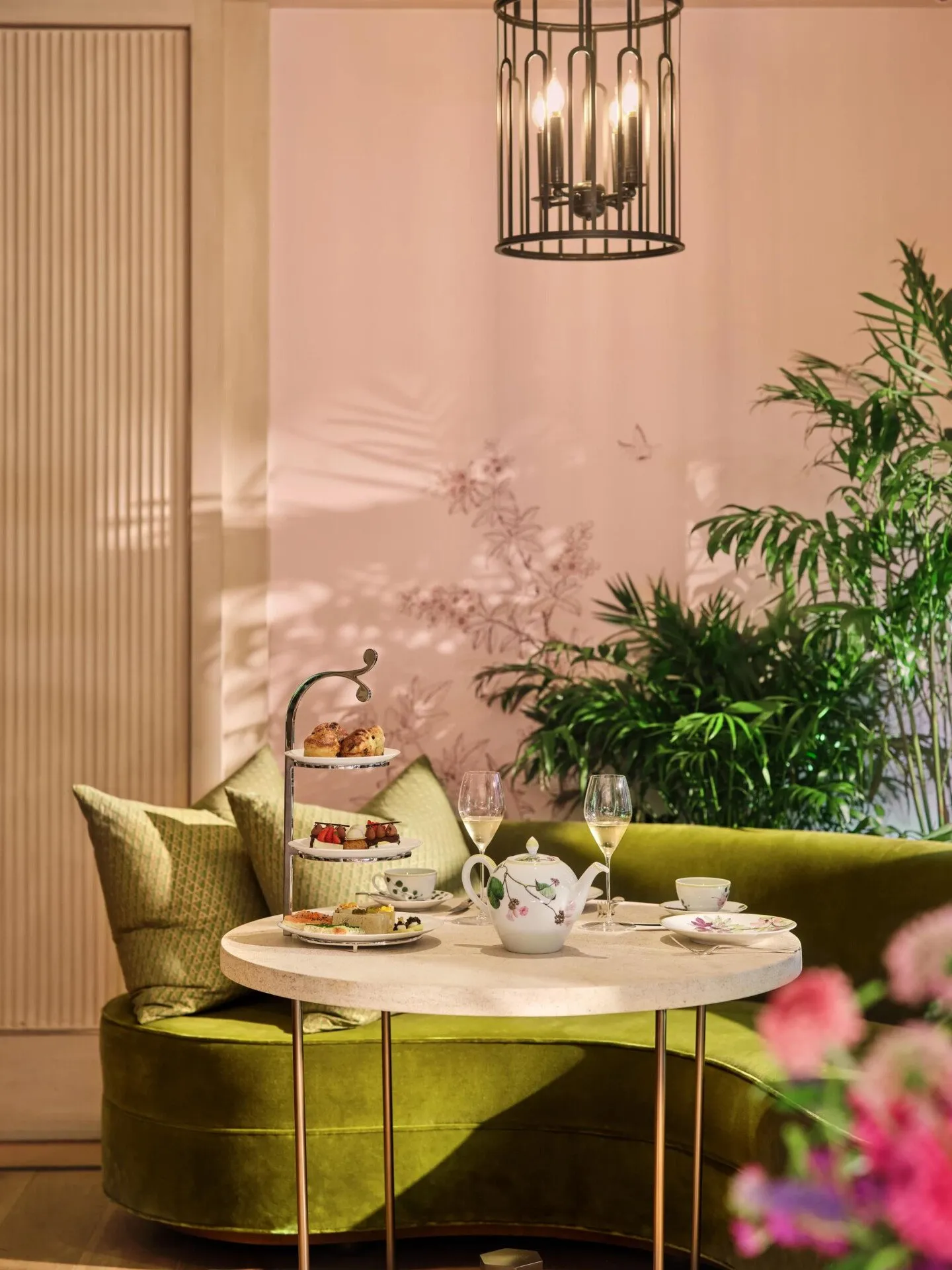 A tea table with its tiered stand in a green corner of The Living Room