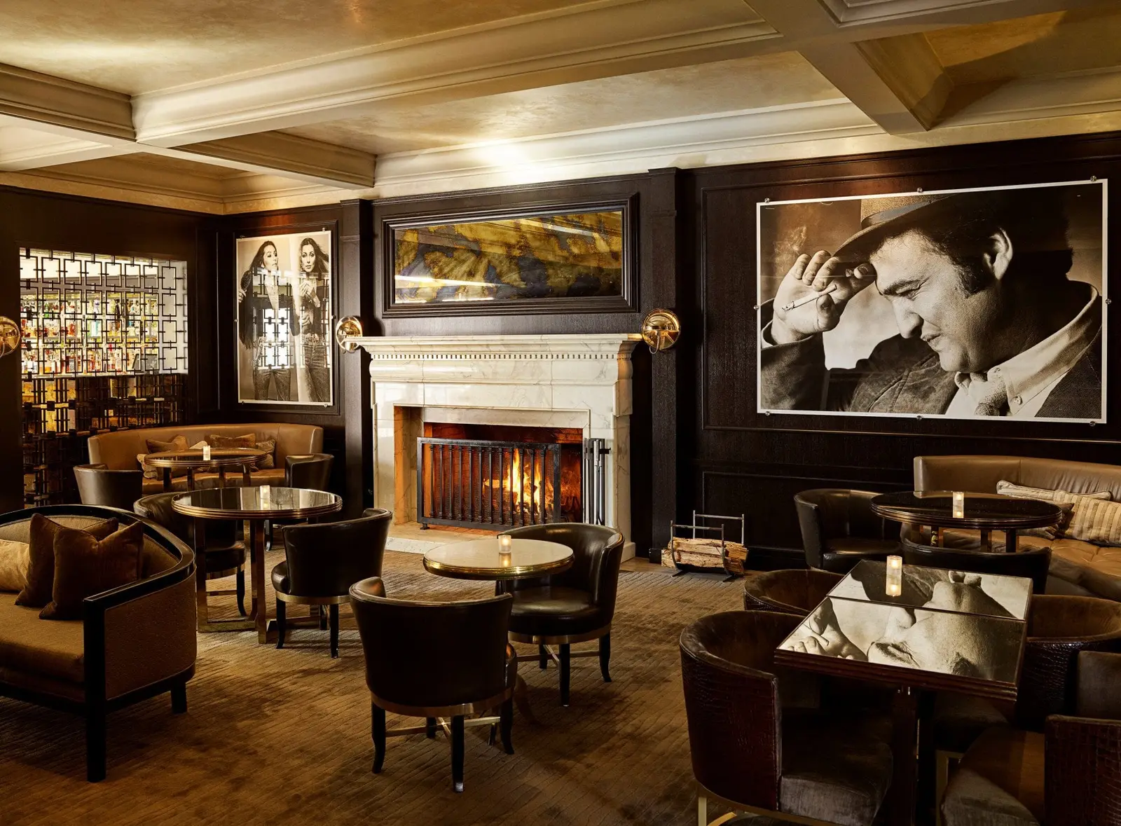 The Bar & Lounge with the fire lit and large black-and-white portraits
