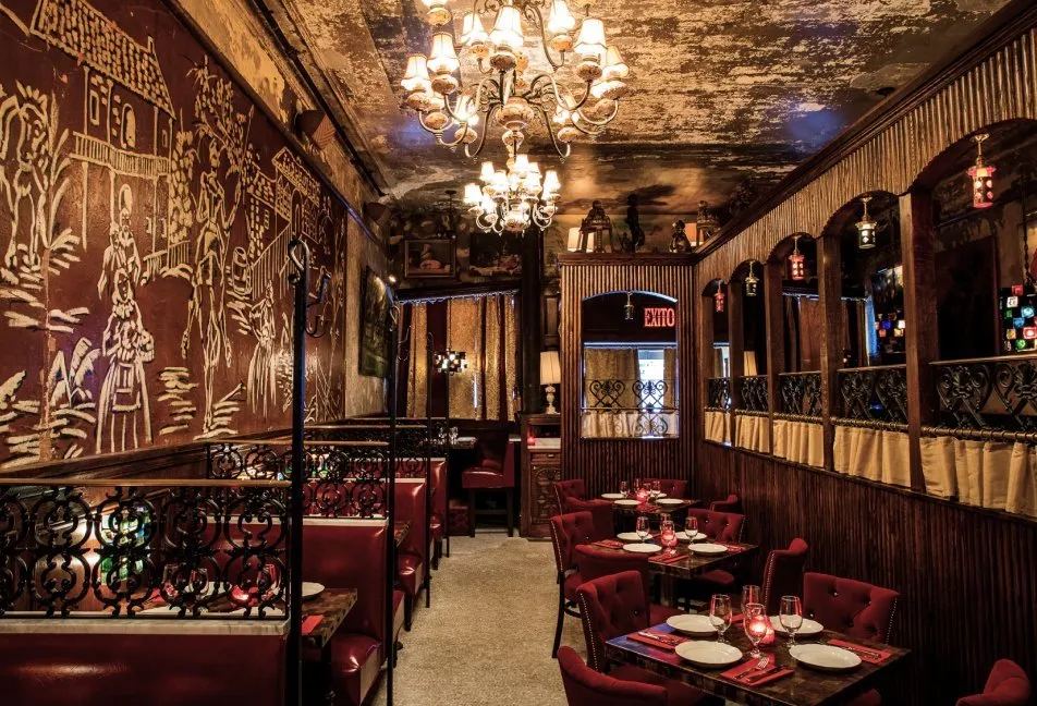 El Quijote’s dining room: the windmill mural on the wall, the chandeliers, the red chairs