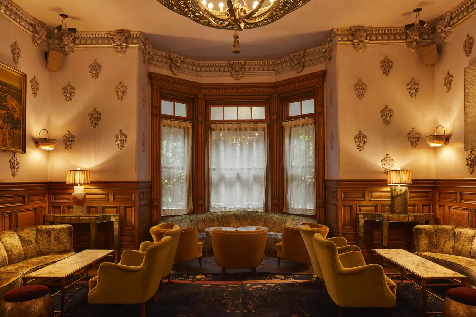 Café Chelsea’s room with mustard armchairs beneath the bay window