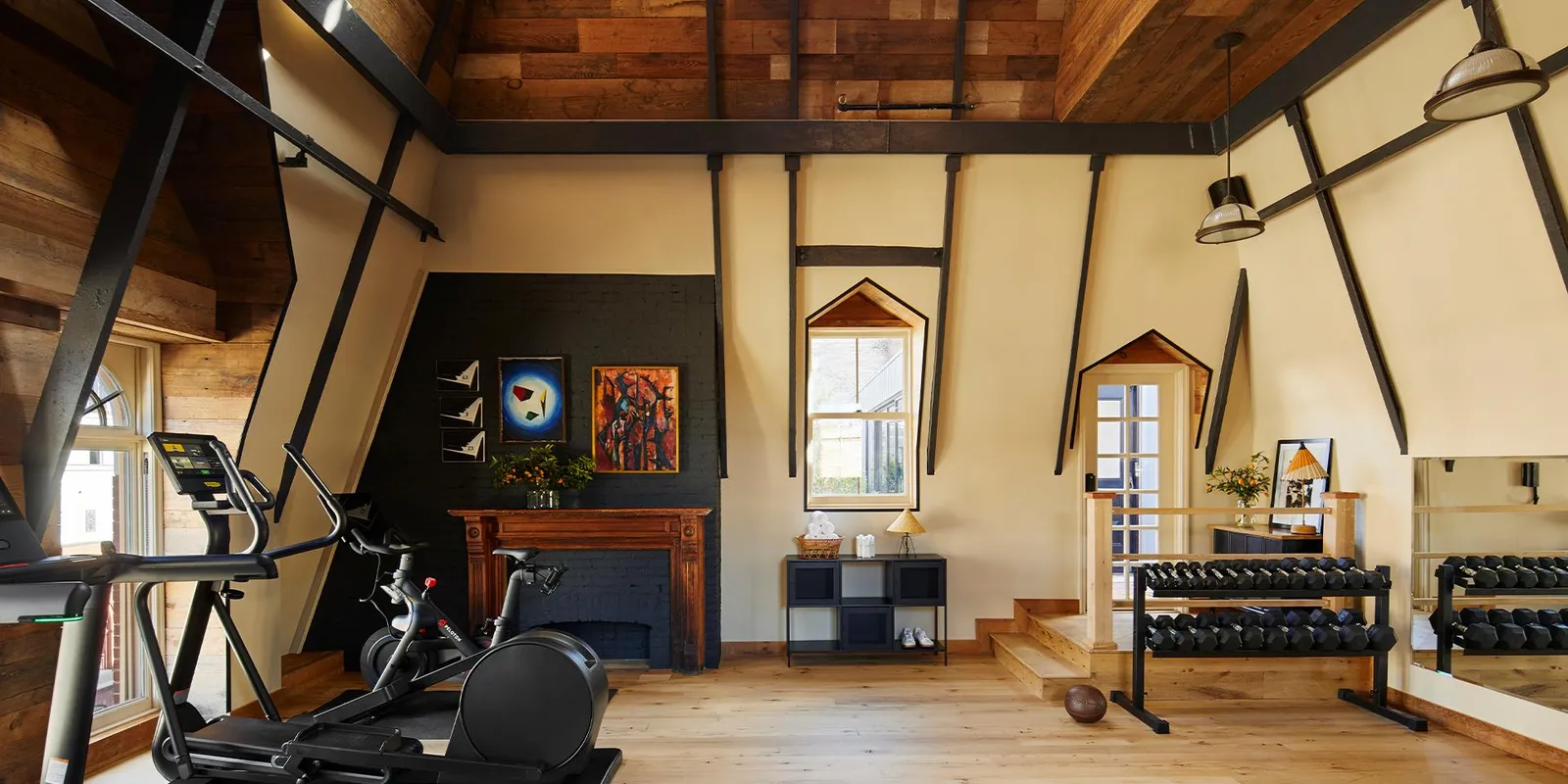 The gym under the steeple’s pitched roof, timber beams and tall windows