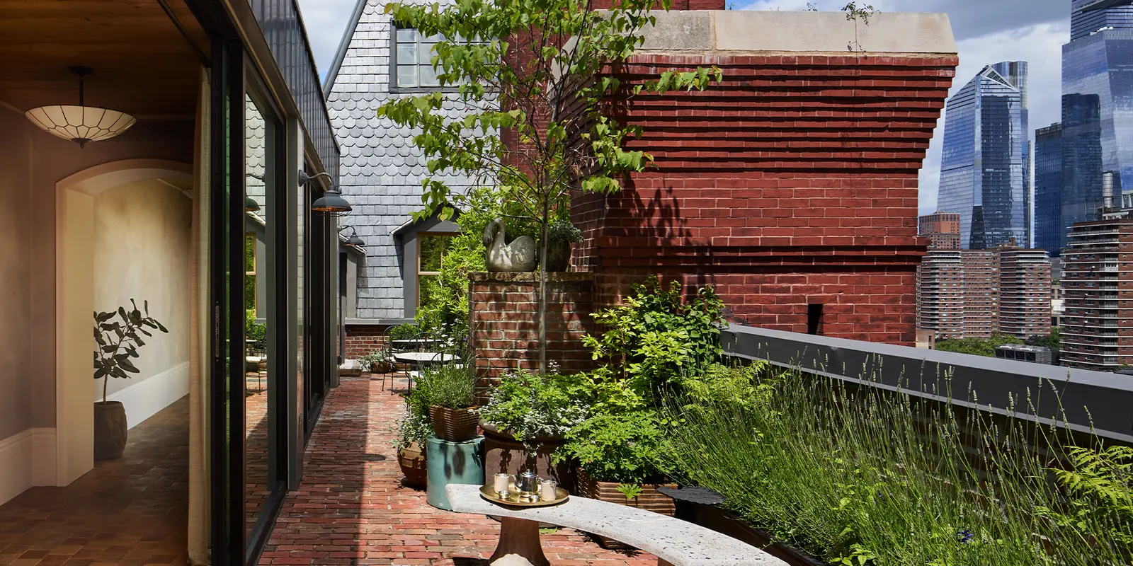 The spa’s roof terrace, plants among the bricks and the Hudson Yards towers behind
