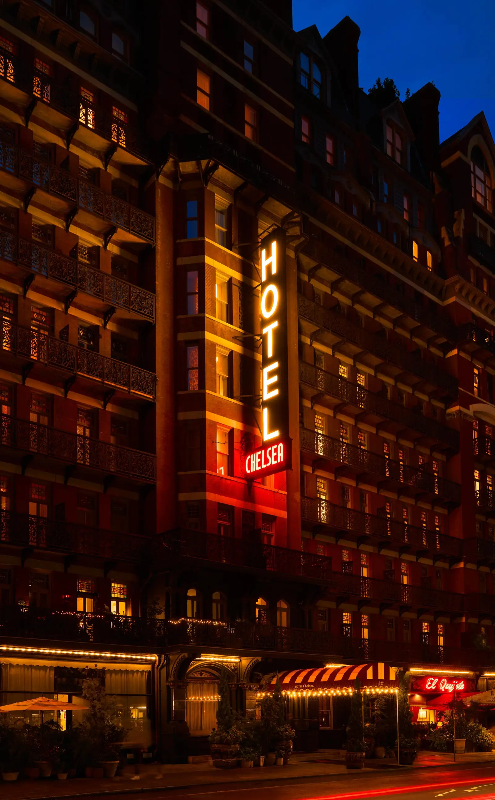 The whole façade at night, 12 storeys of brick with the sign lit