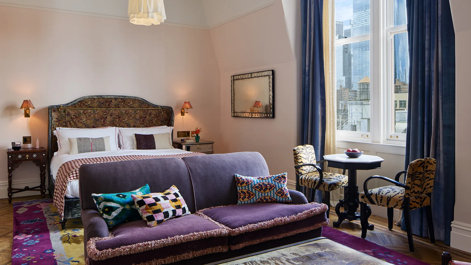 A Chelsea Loft with the bed, a purple sofa and the window onto the towers