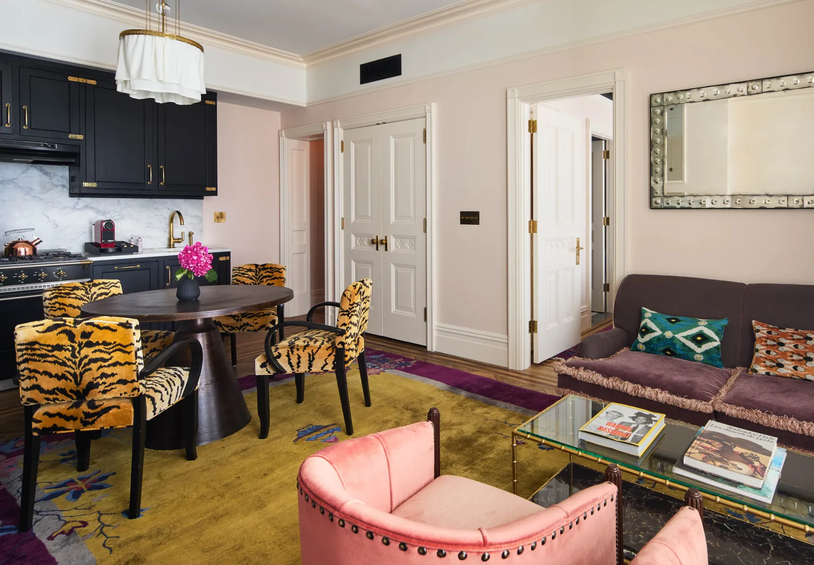 The Studio Suite with its open kitchen, the table and a sofa by the window