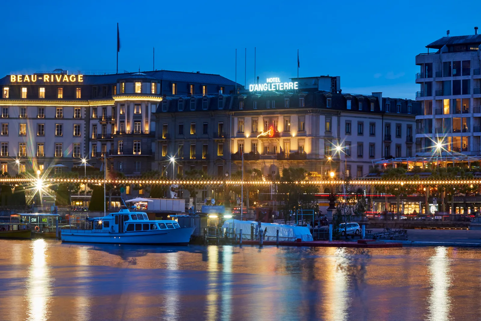 The lakefront at night, with the d’Angleterre sign lit