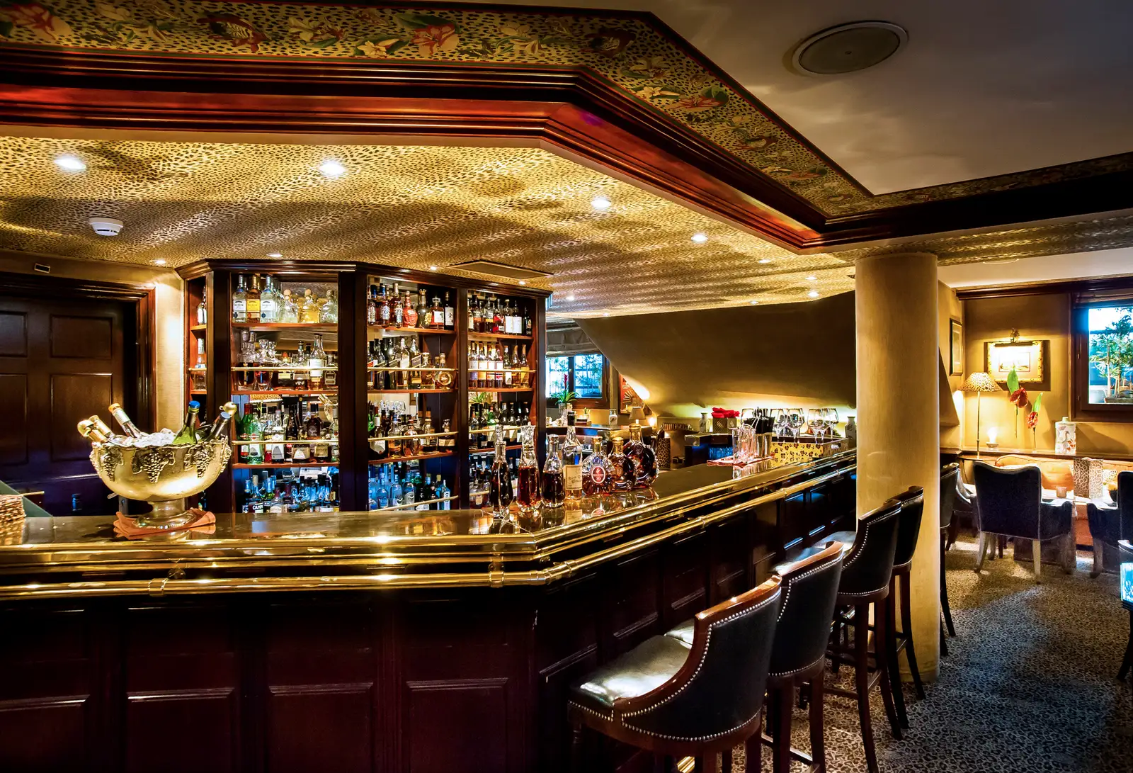 The Leopard Bar counter, with its lit shelves of bottles