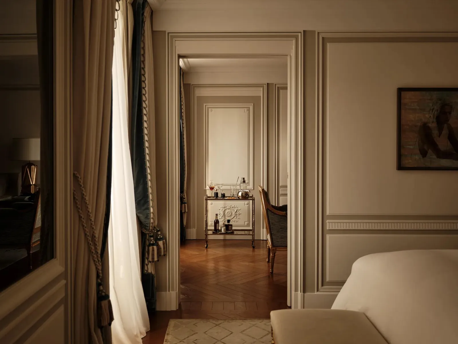 View from a bed towards open sitting-room doors
