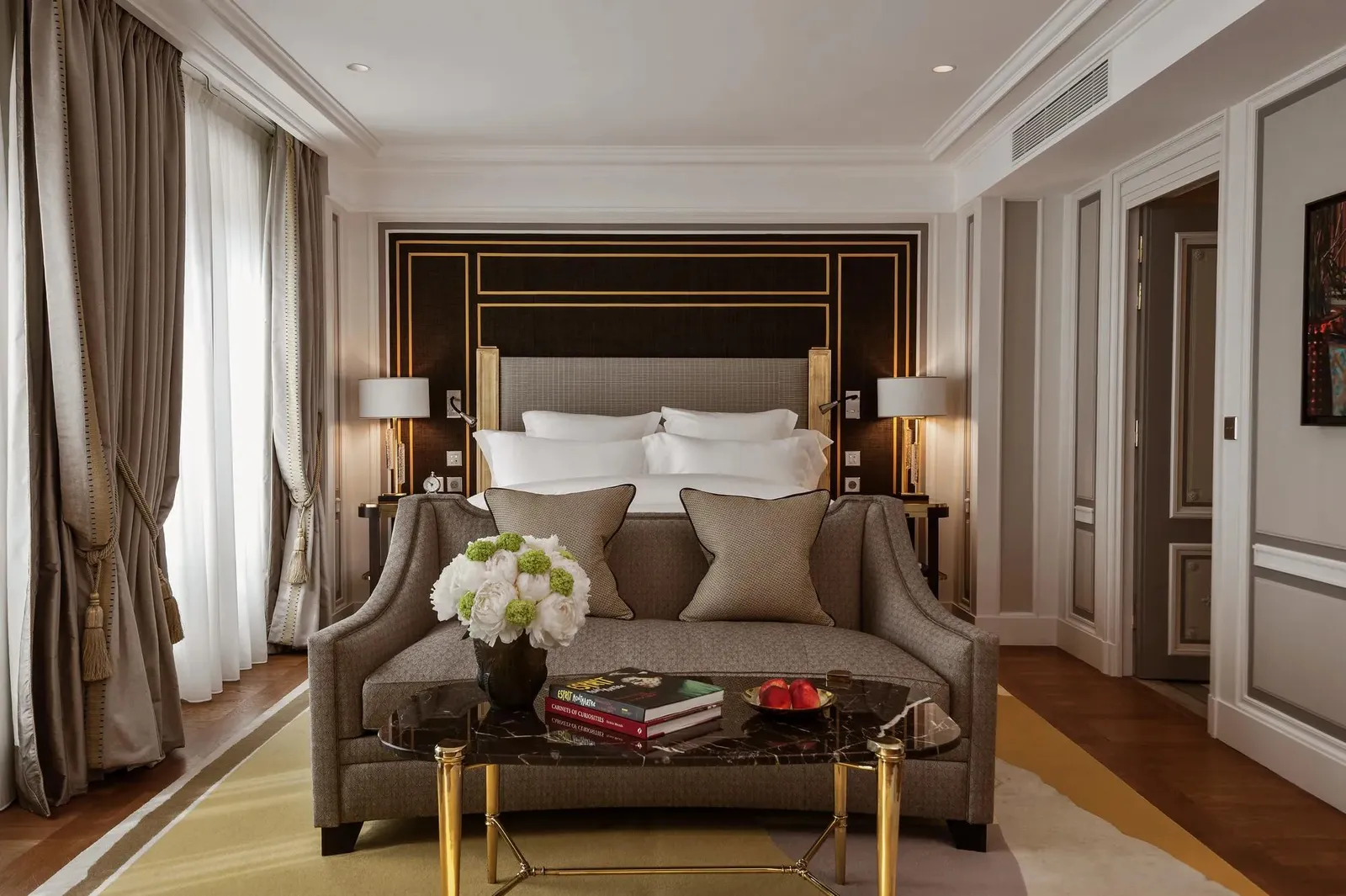A bed behind a sofa and coffee table