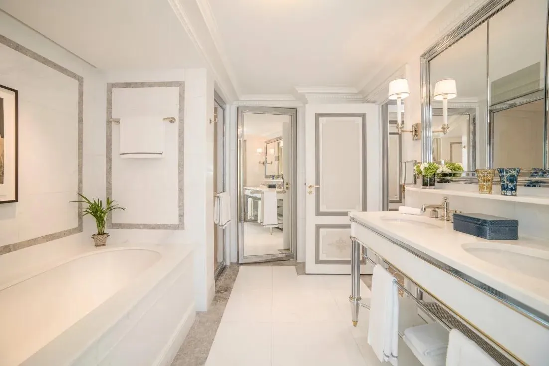 Pale bathroom with mirrors and double basins