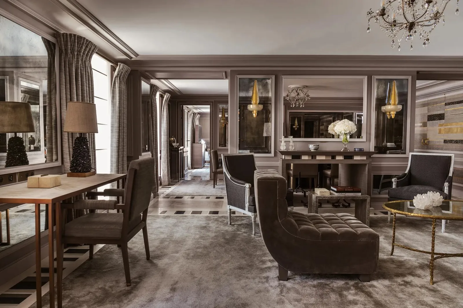 Sitting room with a fireplace, table and dark armchairs