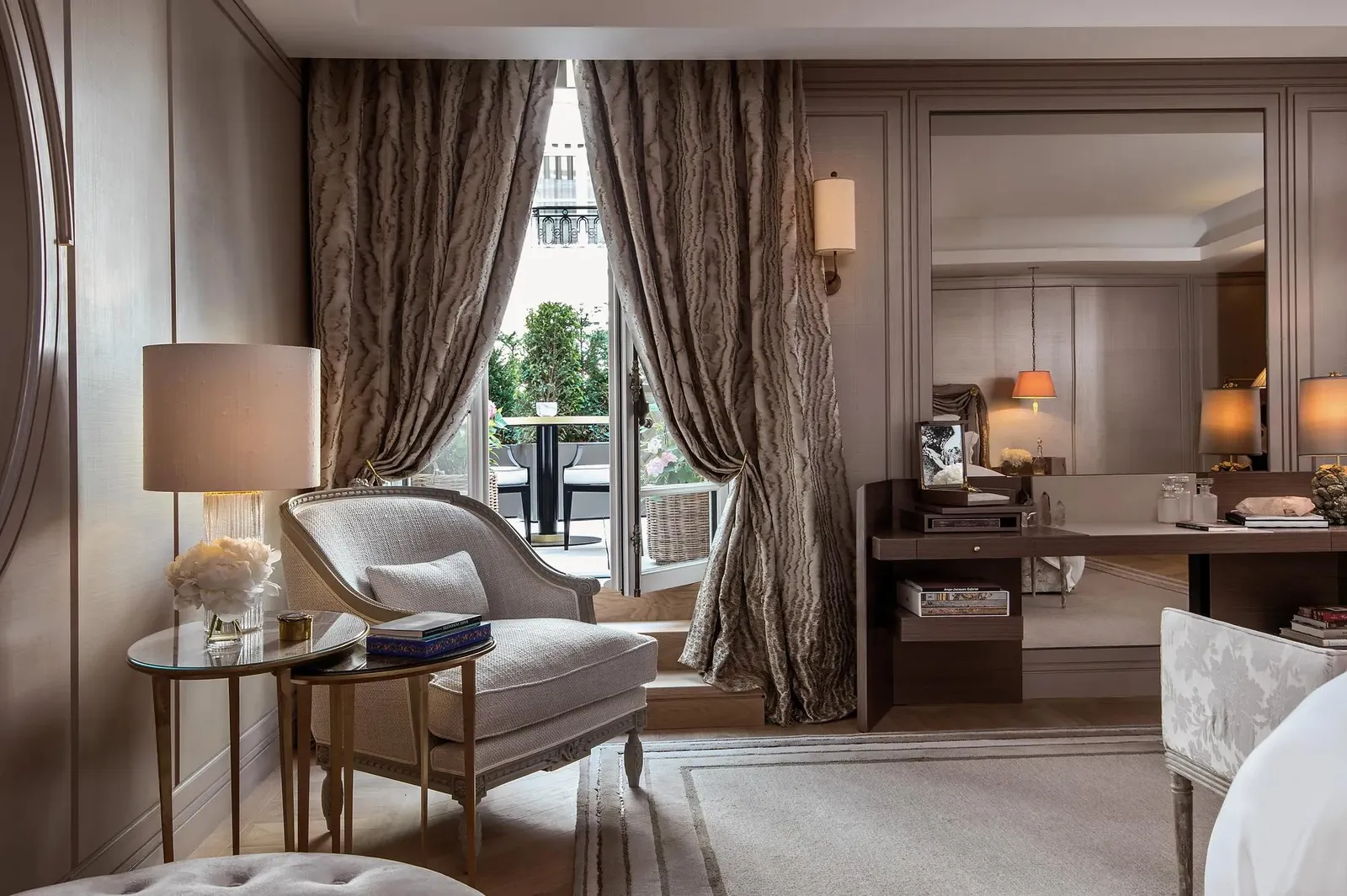 Sitting room with armchairs and curtains, seen from the adjoining room