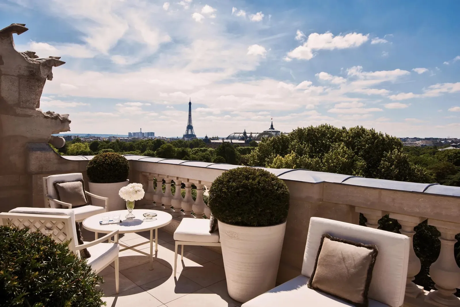 Terrace with a table, chairs and the Eiffel Tower in the distance
