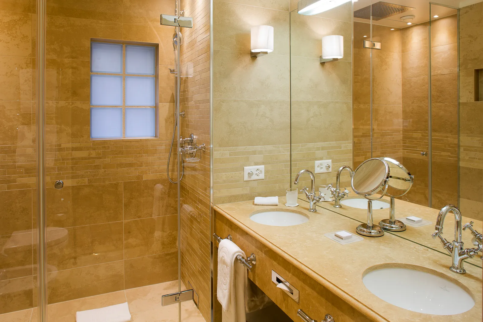 A marble bathroom with 2 basins