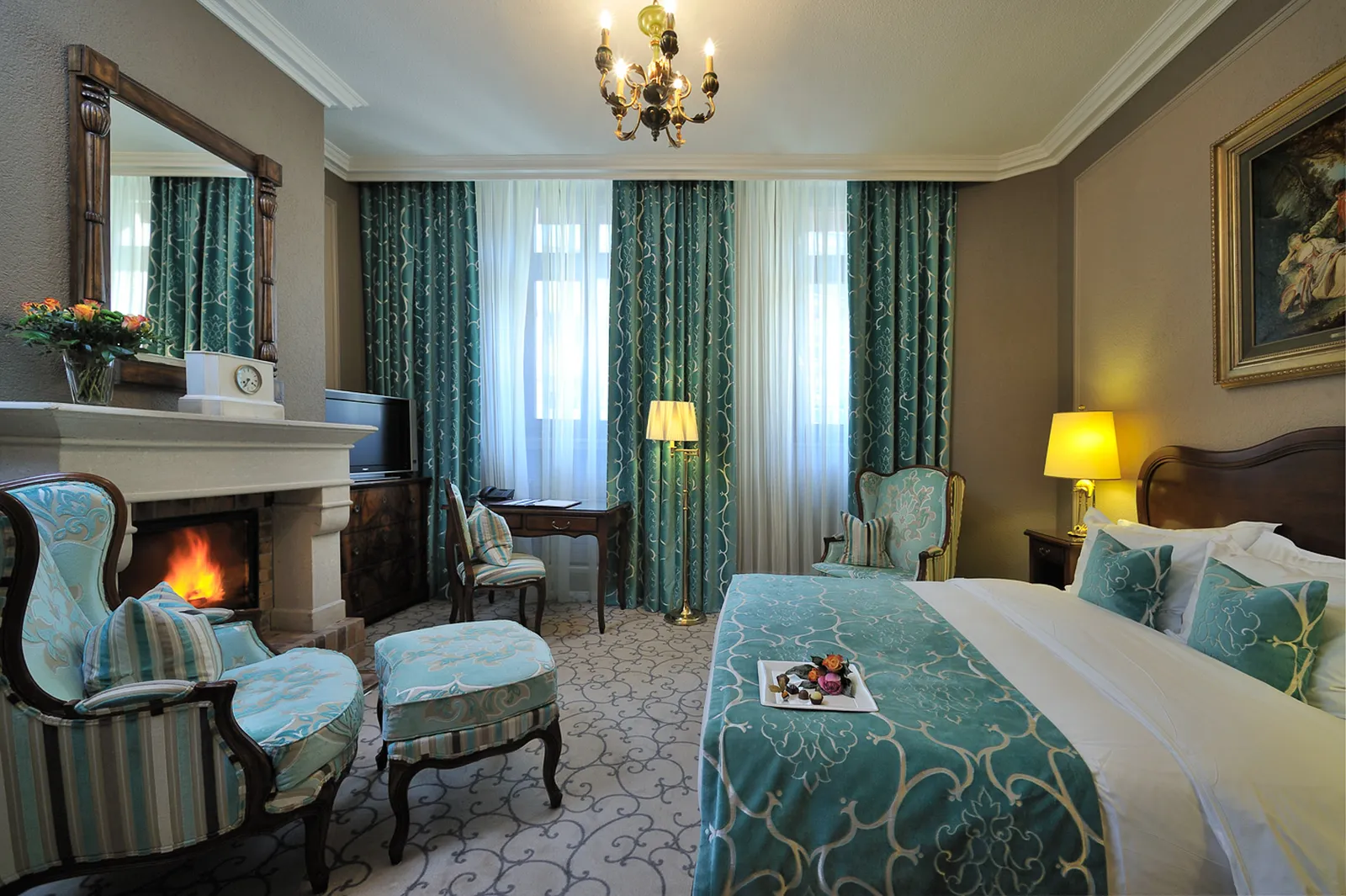 A room with a fireplace and teal curtains