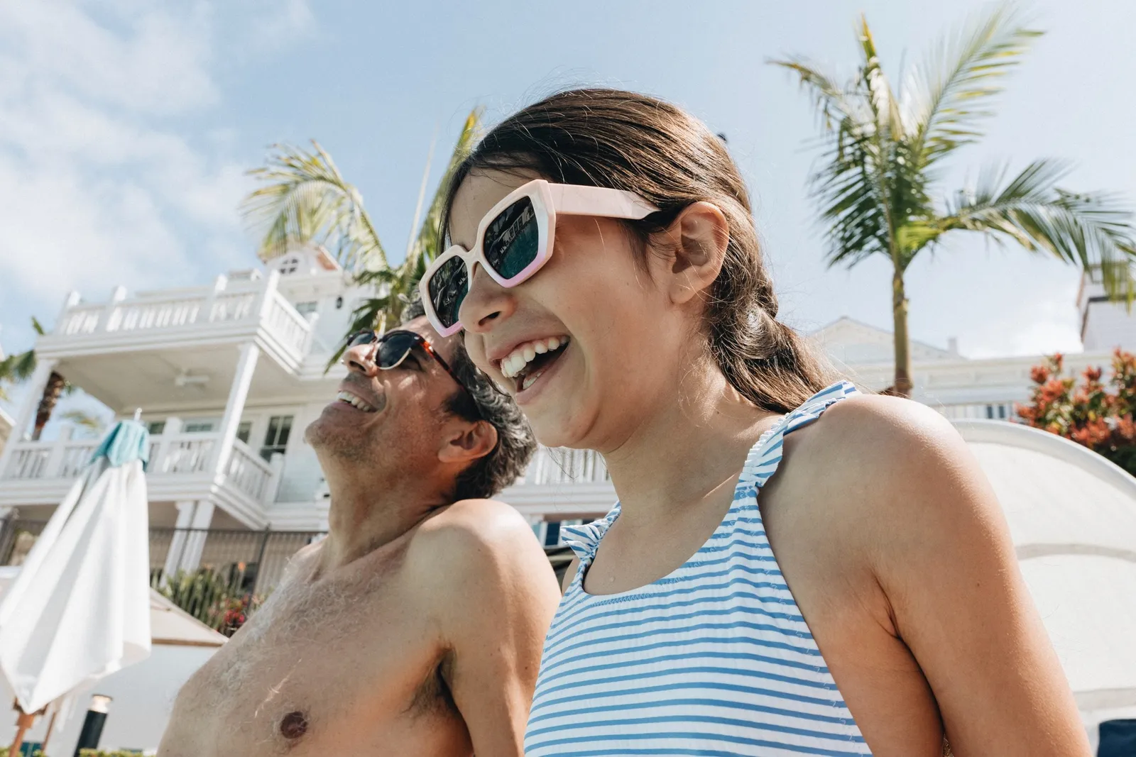 A father and daughter laugh in the Beach Village pool