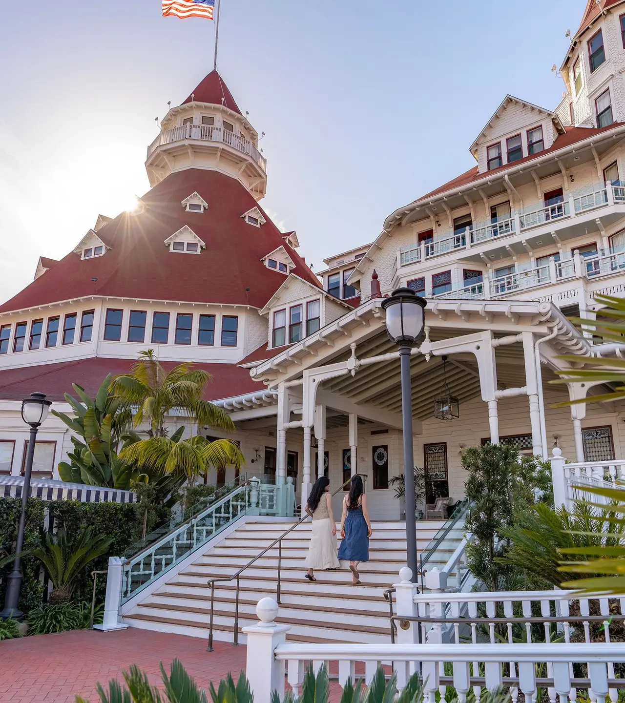 2 guests climb the steps at the Victorian entrance