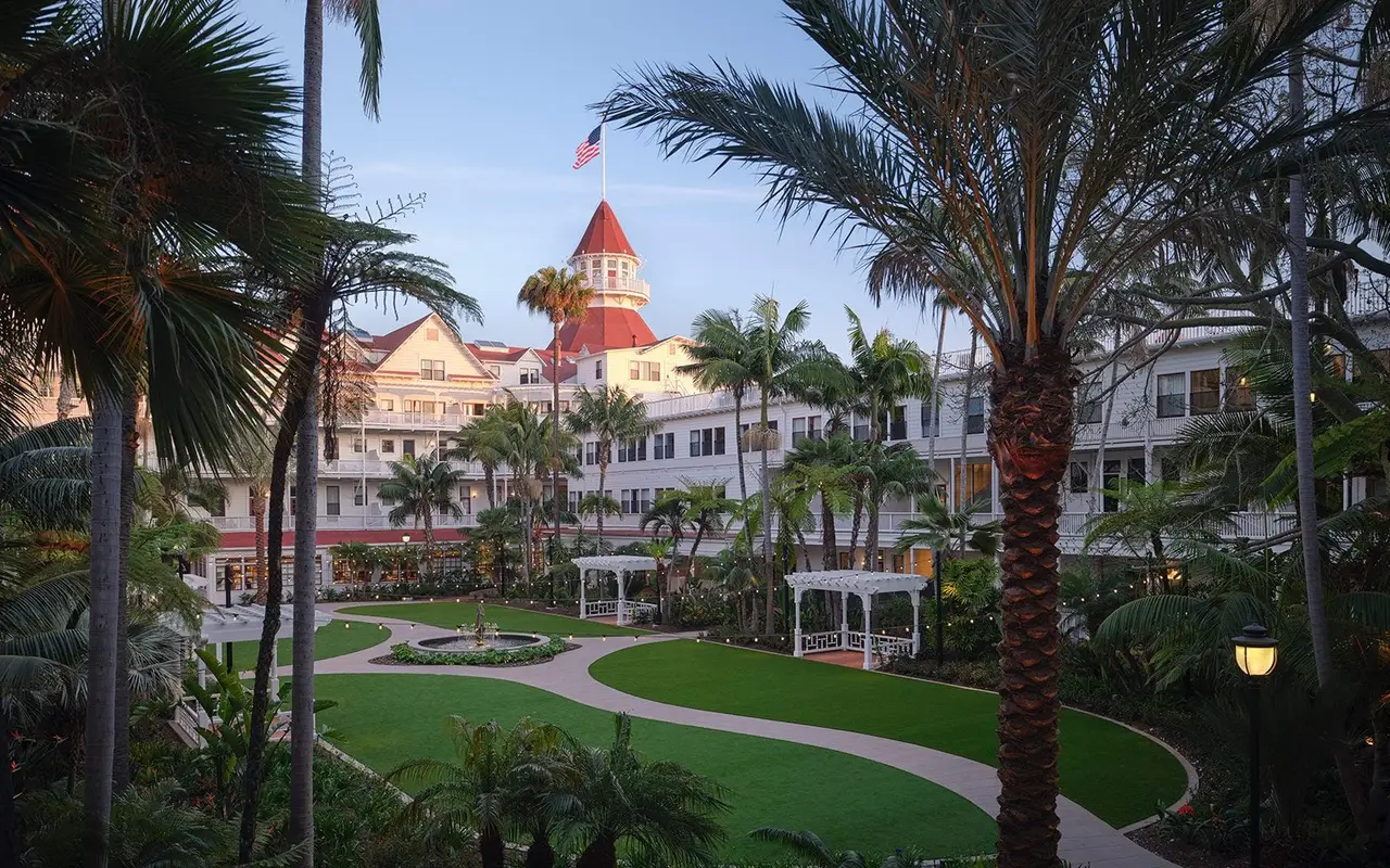 The Victorian garden courtyard with a red turret beyond the trees